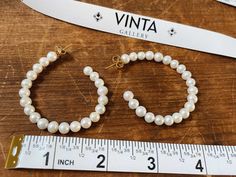 Complete your Filipiniana 'fit with beautiful and bold freshwater Palawan pearl loops. No one pearl will look the same, because nature is gorgeous that way, but we have handpicked the roundest pearly whites. Each loop is set with 16 freshwater Palawan pearls. Loop diameter is 35 mm, or 1.5". Each pearl is between 5-6 mm. These earrings will come in a black velvet box. Studs and backing are made of gold tone stainless steel, will not tarnish! Shipping Price is in USD, which includes standard ship Pearl Bali Earrings, Pearl White Akoya Pearl Chain Earrings, Delicate Akoya Pearl Earrings, Classic White Hallmarked Pearl Earrings, Classic Hallmarked Akoya Pearl Jewelry, Loop Earrings, Palawan, Pearl Studs, Black Velvet