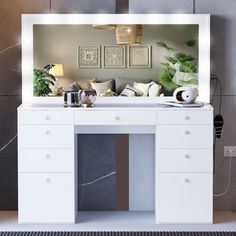 a white desk with a mirror above it and plants on the wall next to it