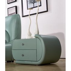 two white vases sitting on top of a green chair