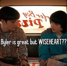 a man and woman sitting next to each other in front of a sign that says, buyer is great but wise heart?