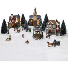 a christmas village with people and horses in the snow