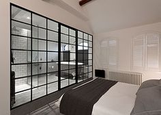 a bedroom with white walls and black accents