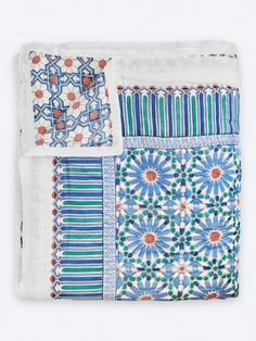 four pieces of blue and white cloth with different designs on them, all folded together