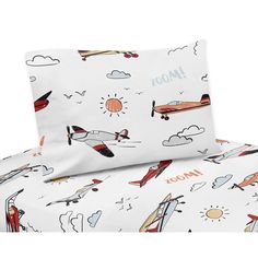 an image of a bed set with airplanes and clouds on the sheet cover, pillowcases