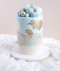 a blue and gold cake on a white plate