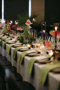 a long table is set with candles and flowers for an elegant dinner or party event