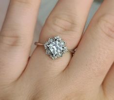 a woman's hand with a diamond ring on her finger and an engagement band