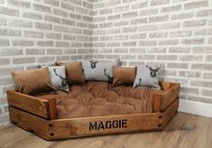 a couch made out of an old wooden crate with cushions and deer heads on it