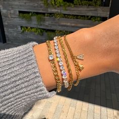 Our Diamond Tennis Bracelet has a unique look that makes it perfect for wearing alone or layering. This bracelet is made using a real 18k gold dipped stainless steel chain and cubic zirconia crystals, which makes it stand out from all the rest. A beautiful piece of jewelry made in California by women who know what they love! ✔Hypoallergenic ✔Quality Guaranteed ✔Water Resistant ✔Handmade COLOR: gold LENGTH: 6.5 inches SIZE: 4mm stones MATERIAL: Stainless steel dipped in 18k gold, cubic zirconia Chic Gold-tone Chain Bracelet, Luxury Gold-tone Bracelet With Chain, Luxury Gold Tennis Bracelet, Elegant Style, Chic Luxury Gold-tone Chain Bracelet, Luxury Gold-tone Polished Finish Chain Bracelet, Diamond Tennis Bracelet, Figaro Chains, Figaro Chain, Tennis Bracelet Diamond