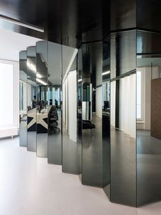 an office with glass partitions in the middle