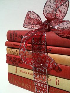 a stack of books with a bow on top