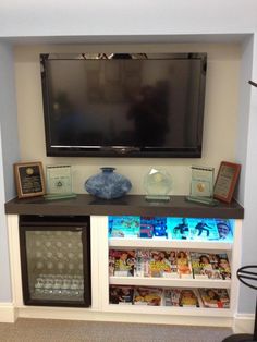 a television mounted on top of a white entertainment center