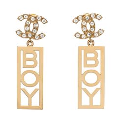 This is an authentic pair of CHANEL Metal Crystal CC Boy Drop Earrings in Gold. These stunning earrings feature a gold drop that says "BOY" with a Chanel CC encrusted with crystals. Drop Earrings Gold, Earrings In Gold, Stunning Earrings, Gold Drop Earrings, Earrings Gold, Gold Earrings, Chanel, Drop Earrings, Crystals