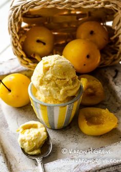 an ice cream sundae with lemons and apples in the basket next to it