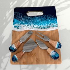 a cutting board topped with knives and spatulas