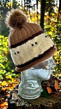 a knitted hat on top of a head in the woods