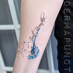 a woman's arm with a dandelion tattoo that reads, thank you