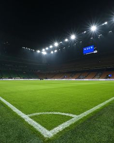 an empty soccer field at night with bright lights