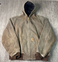 Vintage 90s Carhartt Workwear Carpenter Heavy Duty Winter Spring 1990s Fashion Essential Brown Zip Up Coat Double Extra Large Tall Mens Condition:  Fair Used Condition  = Staining And Distressing Due To Age And Wear Measurements: Please see photos above for all measurements IF YOU BUY TWO OR MORE ITEMS USE THE CODE BUNDLE @ CHECK TO SAVE 20% WE SHIP WITHIN 24 HOURS AFTER PURCHASE! Please be aware that we do not offer free returns!! The Buyer is responsible for the cost of the return label. Follow us on TikTok & Instagram @findsnostalgic and tag us in your finds Carhartt Work Coat, Carhartt Shoreline Jacket, Cheap Dark Wash Everyday Outerwear, Cheap Vintage Long Sleeve Utility Jacket, Cheap Vintage Outerwear For Outdoor, Cheap Fall Outerwear For Urban Adventures, Cheap Everyday Gap Outerwear, Cheap 90s Style Outdoor Outerwear, Carhartt Wip Hooded Chase Jacket