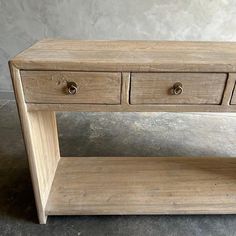 a wooden table with three drawers on it