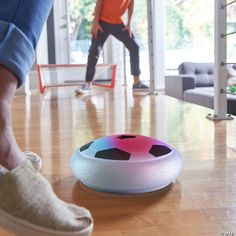 a person standing next to a colorful object on the floor