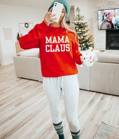 Get into the holiday spirit with our Mama Claus sweatshirt, the ultimate Christmas must-have for moms. Crafted from a super soft and cozy material, this sweatshirt guarantees a snug fit and all-day comfort. Perfect for festive gatherings or snuggling up by the fire, it's the ideal companion during the most wonderful time of the year. Embrace the magic of Christmas in style, and let the world know you're a proud Mama Claus, spreading love and warmth with every wear. Specifications: Brand: Gildan Mama Claus Sweatshirt, Mama Tee, Oversized Graphic Tee, Ultimate Christmas, Cozy Fabric, Trendy Graphic Tees, Mama Sweatshirt, Christmas Mom, Mom Sweatshirt