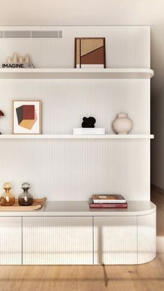 a white shelf with books and vases sitting on it's sides in a room