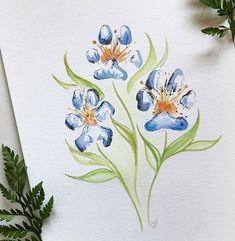 watercolor painting of blue flowers on white paper with green leaves next to it and plant