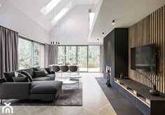 a modern living room with wood paneling and large windows