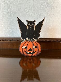 an owl sitting on top of a pumpkin