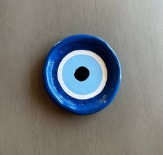 a blue bowl with an eye painted on it