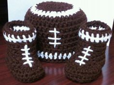 crocheted football boots and booties sitting on top of a wooden table