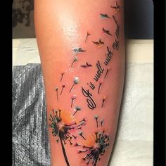 a woman's leg with a dandelion tattoo on it and words written in black ink