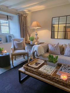 a living room filled with furniture and candles