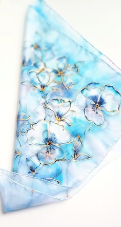 Blossoms art scarf in watercolor style. Lovely intense shades of cold blue, turquoise and shiny gold. A truly spectacular piece. Hand painted 100% silk with hand-rolled edges. Painted on Crepe de Chine (aka Cdc) pure silk. Crepe de chine is similar to habotai or ponge 05 silk but it has a shinier surface and a wonderfully smooth touch. The silk dyes are non-toxic and permanent, so the scarf is hand-washable. Ships with English washing instructions. The scarf is long enough to twist around your n Elegant Hand Painted Blue Silk Scarf, Elegant Hand-dyed Silk Scarf Gift, Artistic Blue Silk Scarves, Artistic Hand-dyed Silk Scarves, Luxury Artistic Hand-painted Silk Scarf, Art Scarves, Blossoms Art, Mild Shampoo, Silk Scarf Painting