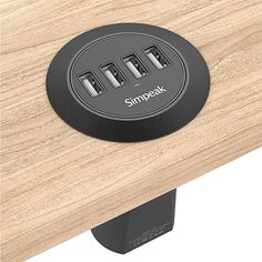 an image of a wooden table with three outlets