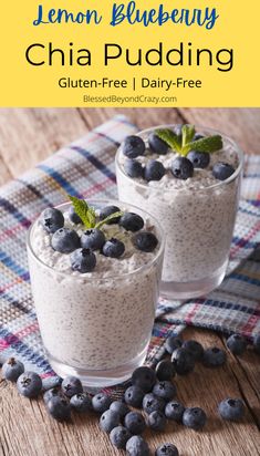 two glasses filled with chia pudding and blueberries on top of a wooden table