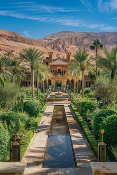 an outdoor garden with palm trees and water features