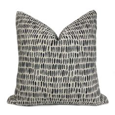 a black and white pillow with an abstract pattern on the front, sitting on a white background