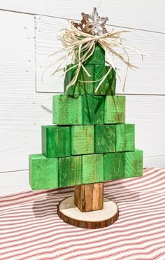 a wooden christmas tree made out of green blocks