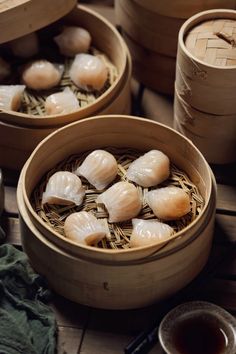 several small bowls filled with dumplings next to chopsticks