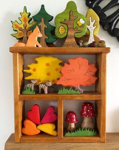 a wooden shelf filled with different types of fall decorations