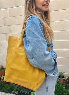 Large tote leather bag in MUSTARD YELLOW. Large shopper bag natural GENUINE leather. Large enough for books or a laptop, tablet, cosmetics bag etc. Leather shopper. The inside of the bag is not lined (although properly finished!) . We added a small leather pouch on the inner part of the bag . The bag can be closed by 2 leather straps attached to each side. Excellent quality soft but strong genuine leather. Width upper part: 41cm - 16 inch Height: 38 cm - 15 inch (CAMEL COLOR AS ON THE FIRST 3 PI Mustard Yellow Purse Outfit, Yellow Bag For Everyday Use In Fall, Yellow Bags For Everyday Use In Fall, Yellow Rectangular Shoulder Bag For Shopping, Trendy Yellow Leather Satchel, Modern Yellow Leather Satchel, Modern Yellow Tote Bag, Modern Yellow Satchel With Large Capacity, Mustard Rectangular Shopping Bag