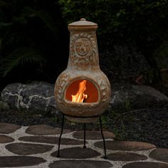 an outdoor fire pit with a face on it