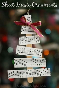 an ornament made out of popsicle sticks with music notes hanging from it