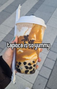 someone holding up a cup with ice cream on it and the caption tapicca is so yummy