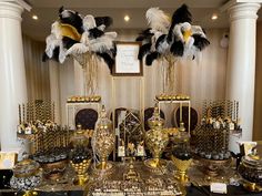 a table topped with lots of gold and black plates covered in confection items