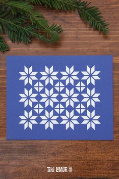 a piece of paper cut out to look like snowflakes on a wooden table