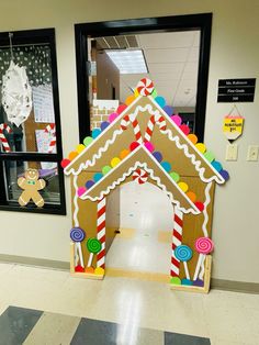 a gingerbread house made out of cardboard on the floor