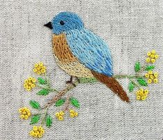 a blue bird is sitting on a branch with yellow flowers